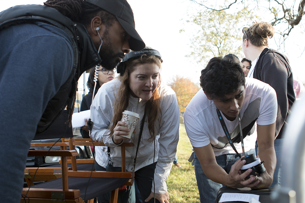 A cinematography student with director Colette Burson pulling focus.